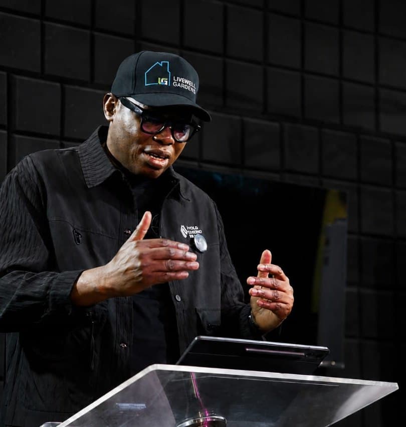 Wole Abraham Martins speaking in a low-lit studio