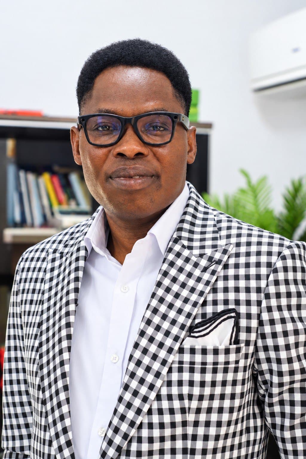 Portrait of Wole Abraham Martins in a gingham jacket